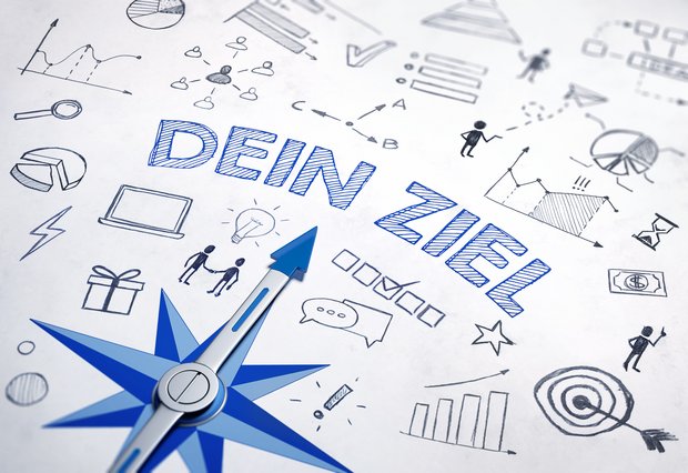Grafik eines Kompass, der auf einen Schriftzug zeigt. Der Schriftzug lautet: Dein Ziel. 
